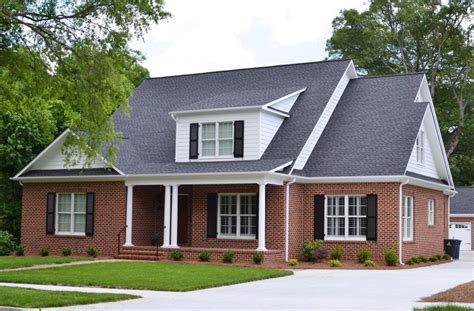 red metal roof on red brick house|black shingles on brick house.